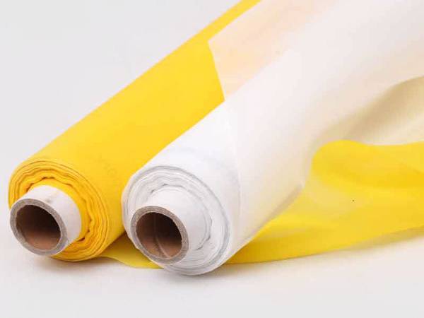 A roll yellow, a roll white Polyester screen printing mesh on gray background.