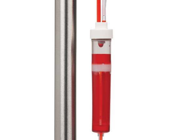 A blood transfusion tubing filter is transfusing blood.