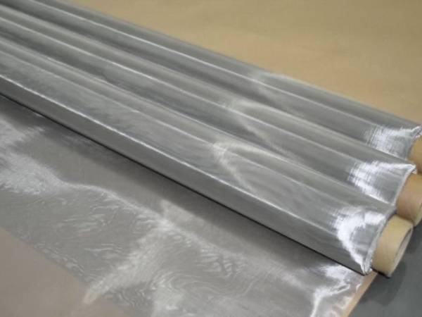 Three rolls of stainless steel screen printing mesh on gray background.